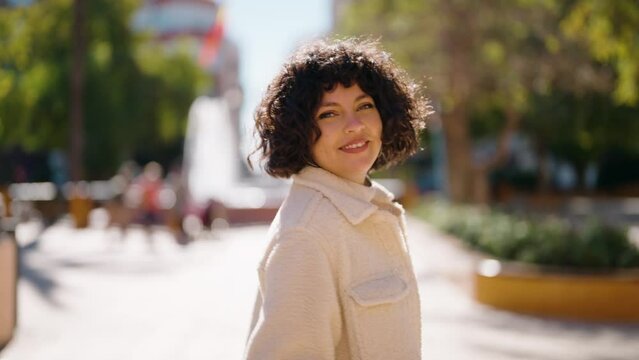 Young hispanic woman smiling confident walking at park