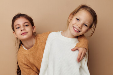 two cute little girls hug friendship childhood posing