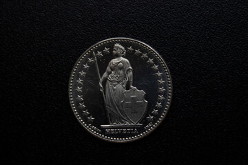 metal coin close-up on a black background.