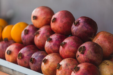 Close-up of bright fruits for background, texture. Red ripe pomegranates on display.