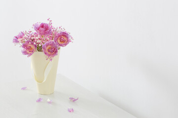 bouquet of pink tulips and gypsophila on white table