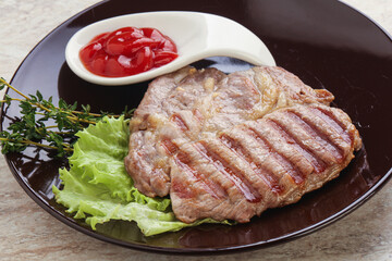Grilled pork neck steak with ketchup