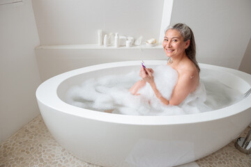 Lady preparing to remove leg hair. Skincare and health