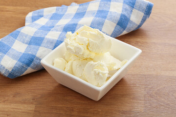 Italian soft mascarpone cheese in the bowl