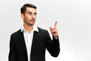 business man showing index finger up in black business suit work successful trader isolated. Copy space