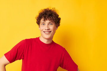 Fototapeta na wymiar portrait of a young curly man red t shirt fun posing casual wear isolated background unaltered