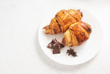 delicious, tasty, crispy croissants, chocolate on plate on light marble table