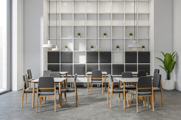 Front view on bright cafe interior with tables with chairs