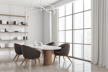Corner view on bright kitchen interior with dining table, window