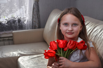 child smiling portrait with flowers on sofa at home living room