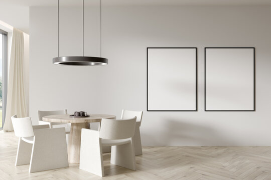 Beige dining room interior with two empty white framed mockup poster on wall, table, armchair Hardwood floor. Concept of minimalist design. Creative idea. Mock up. 3d rendering