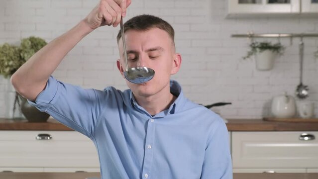 Man testing fresh soup, close-up
