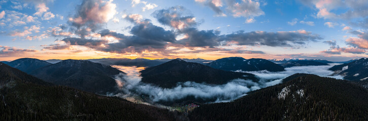 Sunrise in the Carpathians, misty mountains and spruce forests in the nature park.