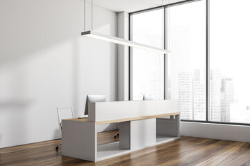 Light reception interior desk with two computers and lamp, window