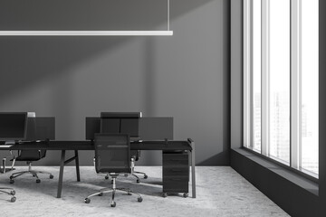 Office room interior with seats, table and computers, window with city view