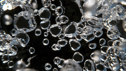 Moving Bubbles on Dark Background, macro shot.