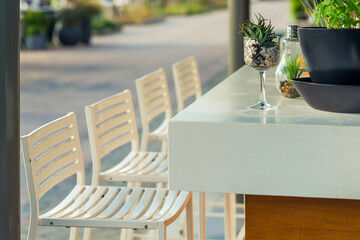 Range of wooden table and white chair for relaxation at restaurant near sea