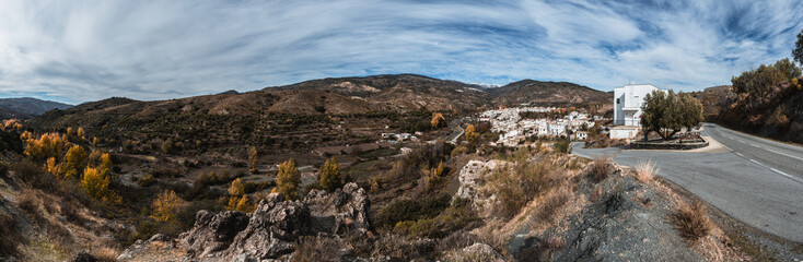 Panoramic view of the white village of Cadiar with the snow capped mountains of the Sierra Nevada in the backgrounds. Alpujarra, Spain