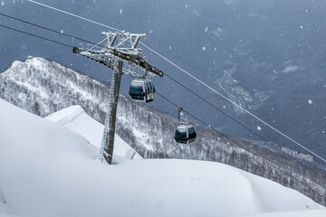 Gondola lifts on ski resort in the winter mountains