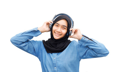 Muslim teenager listening to music with headphone. Isolated on white background.