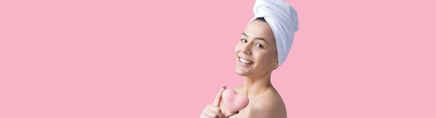 Beauty portrait of woman in white towel on head applies cream to the face. Skincare cleansing eco organic cosmetic spa relax concept.