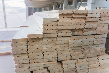 Tongue and groove wooden boards storage. Batten boards with grooves and tongues in market warehouse