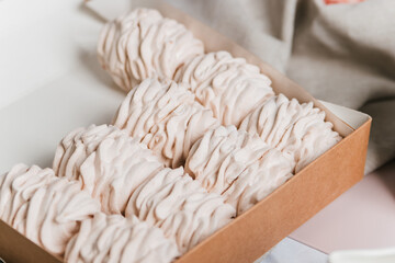 A juicy white marshmallow lies on the table. Delicious dessert for tea.