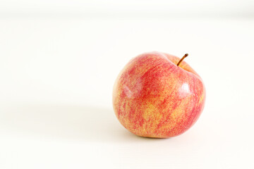 yellow and red apple on white table