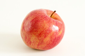 yellow and red apple on white table
