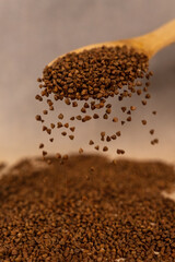 Buckwheat in a spoon.
Scattered buckwheat.