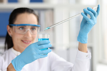 Researcher scientist working with blue liquid test tube in laboratory