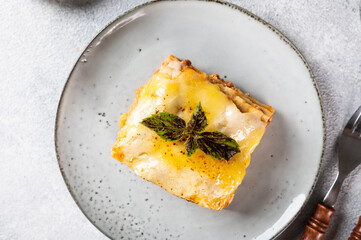 Piece of tasty hot lasagna. Traditional italian lasagna. Italian food. Close up lasagna. Bolognese sauce. Bechamel sauce. Still life of food. Homemade meat lasagna. Top view