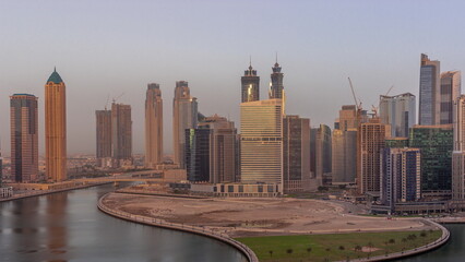 Fototapeta na wymiar Cityscape skyscrapers of Dubai Business Bay with water canal aerial timelapse.