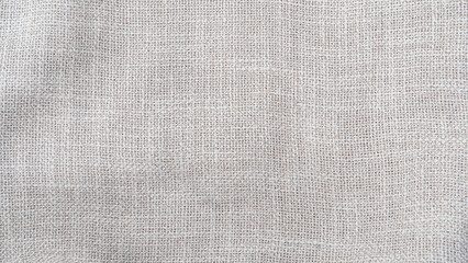 Jute hessian sackcloth woven burlap texture background in sepia cream old aged brown color