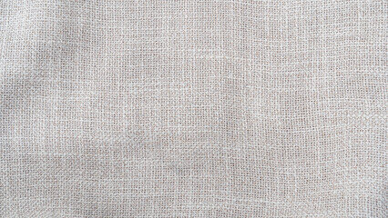 Fototapeta premium Jute hessian sackcloth woven burlap texture background in sepia cream old aged brown color