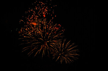 Colorful salute, great explodes in different colors in the night sky, beautifully dissolving in the air.