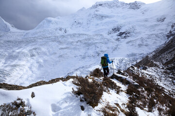 Woman backpacker hiking in winter plateau mountains