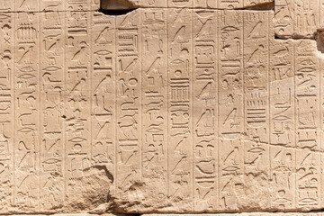 Relief details and Egyptian hieroglyphs at Karnak temple complex in Luxor, Egypt