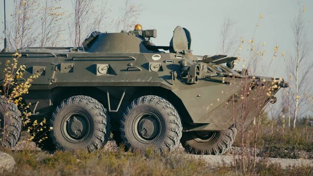 Close-up of an armored personnel carrier of the Russian army riding on the road.
