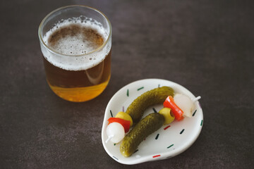 Image of a cold beer with some pickles