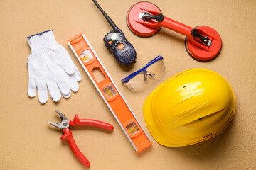 Safety equipment with builder's tools and radio transmitter on color background