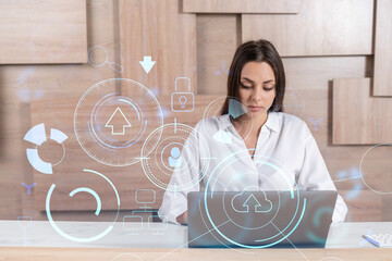 Attractive businesswoman in white shirt at workplace working with laptop to optimize development by...