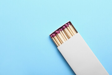 Matchbox with fireplace matches on color background