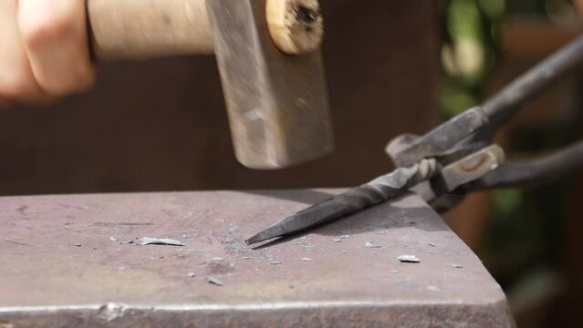 blacksmith hammering metal at medieval forge slow motion 4k