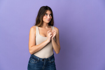 Young caucasian woman isolated on purple background scheming something