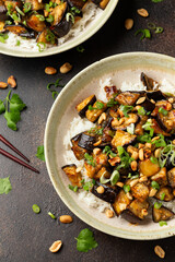 Asian Eggplant with rice, peanuts and spring onion. Healthy food.