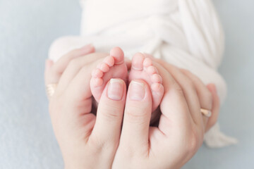 little baby feet holding hands close up 