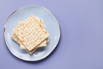 Plate with Jewish flatbread for Passover on color background