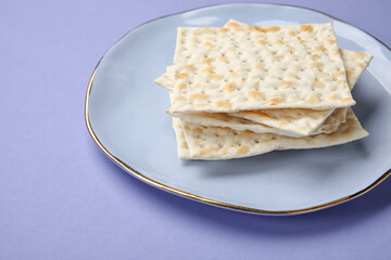 Plate with Jewish flatbread for Passover on color background
