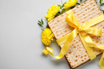 Jewish flatbread with flowers on light background